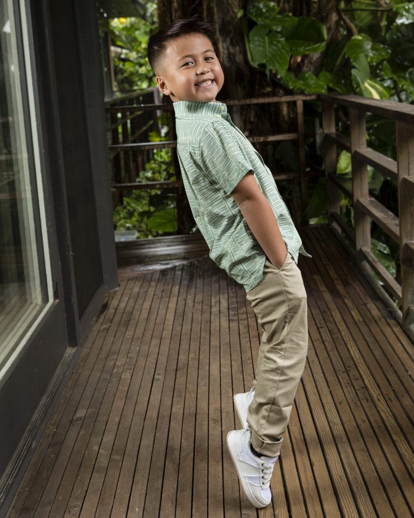 Boy wearing Keiki Shirt in Lily Pad Margarita Kupukupu pattern side view