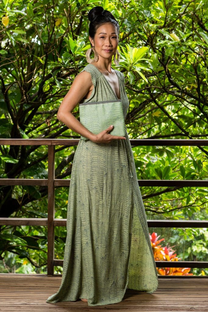 Model holding Flat Zip Pouch in Margarita Lily Pad Kupukupu pattern