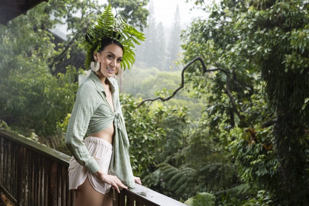 Model wearing Kaka'ako Pullover in Lily Pad Margarita Kupukupu pattern side view