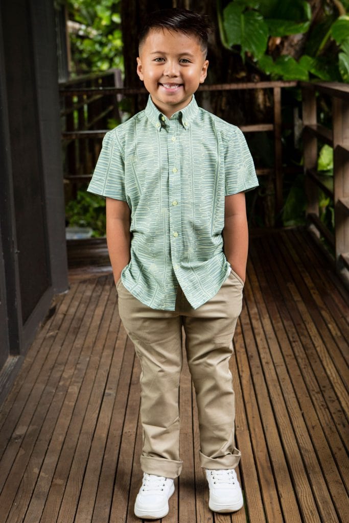 Boy wearing Keiki shirt in Lily Pad Margarita Kupukupu pattern front view