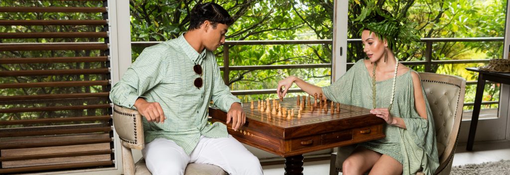 Male and Female Model Playing Chess and Wearing Kupu Collection Clothes