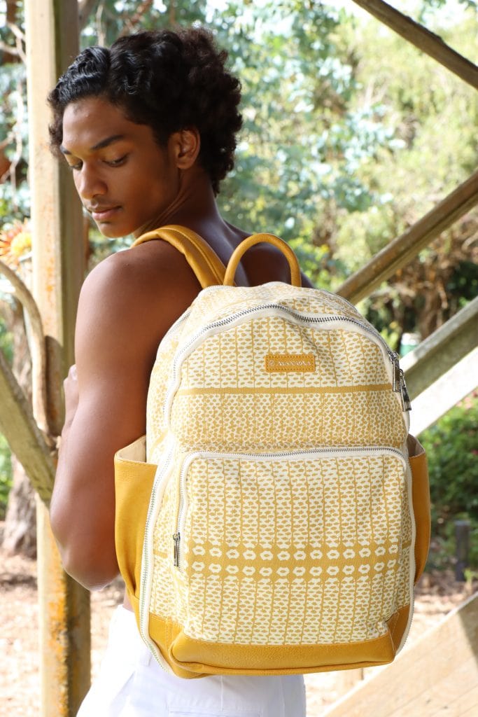 Male model wearing Huakai Backpack in Ako'Ako'a in Rise Color - Back View