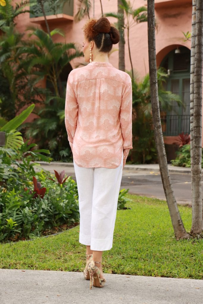 Female Model wearing Malino Shirt in a Kalihilehua Pattern and Lotus-Ash Rose Color - Back View