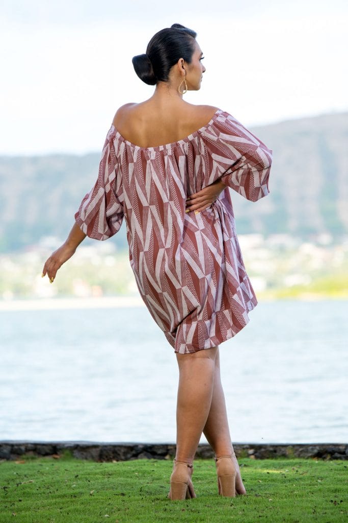 Female Model wearing a Healani Top in a Kanaloa Pattern and Fired Brick-White - Back View