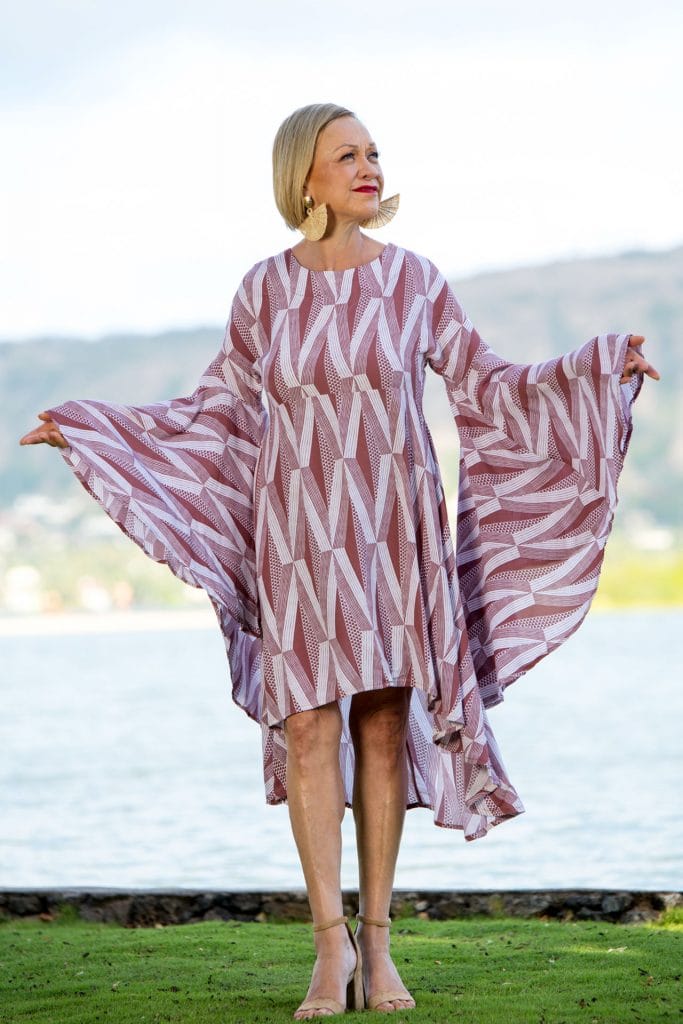 Female model wearing a Lilinoe Short Dress in Kanaloa Pattern and Fired Brick-White - Front View