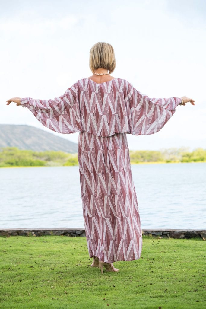 Female model wearing Kikaha Dress in a Kanaola Pattern and Fired