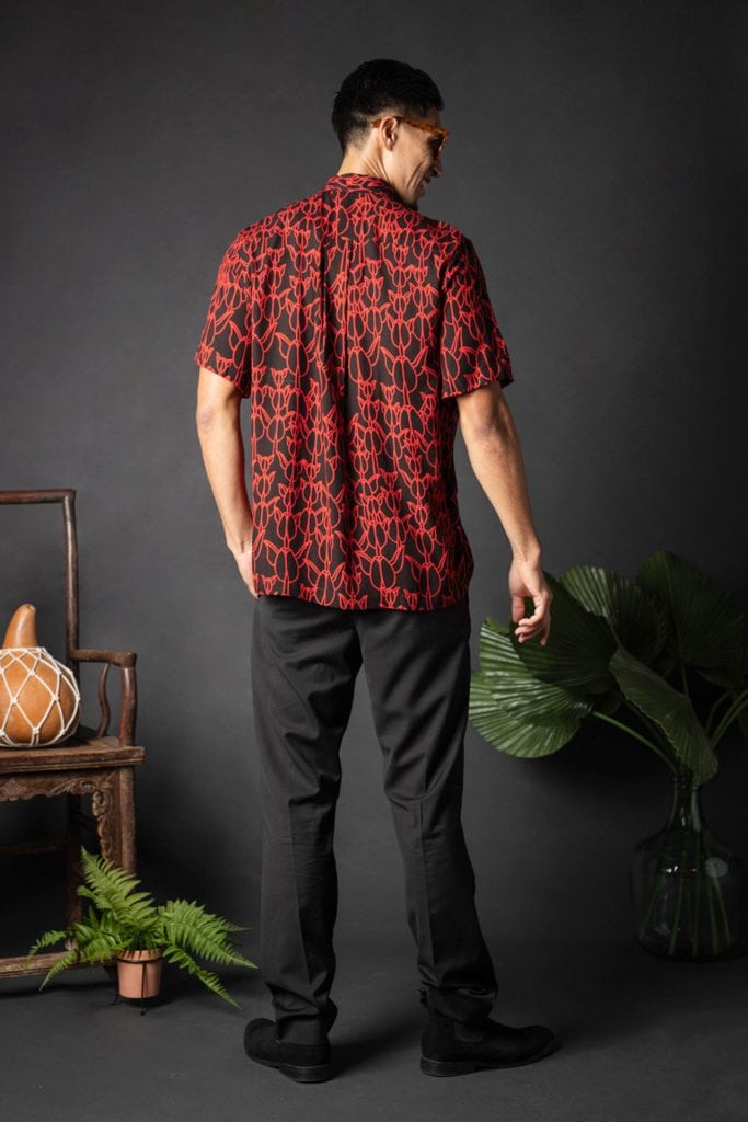 Male model wearing Aloha Shirt S-S in a Kapualiko Pattern and Black-Fiery Red - Back View