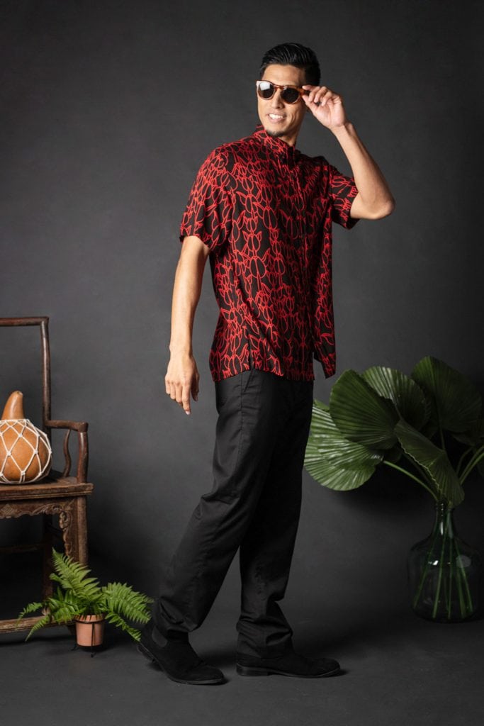 Male model wearing Aloha Shirt S-S in a Kapualiko Pattern and Black-Fiery Red - Side View