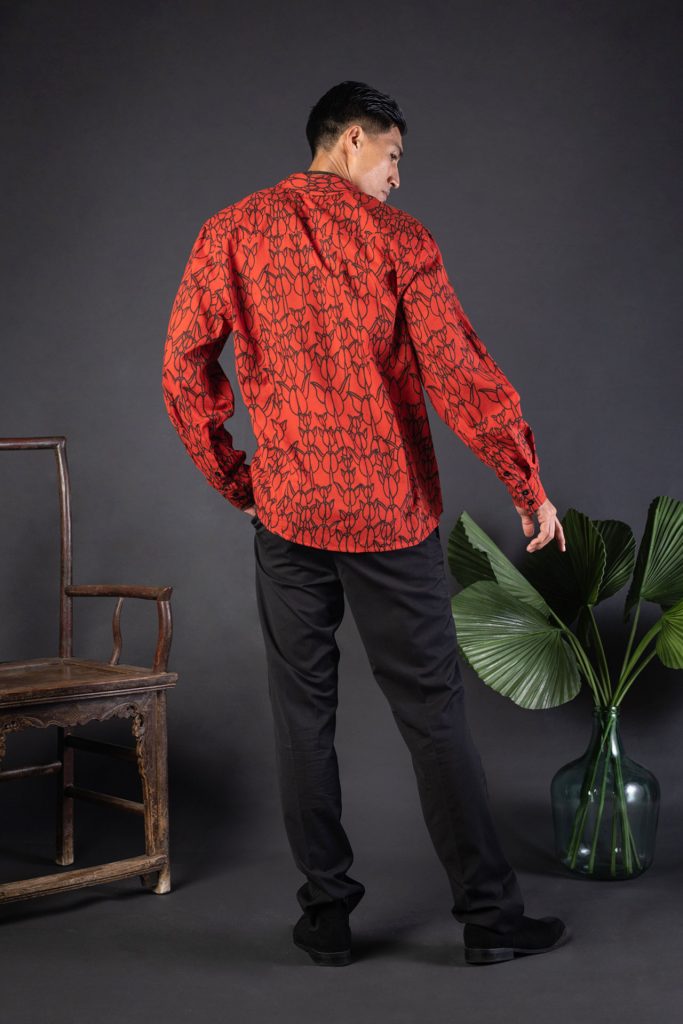 Male model wearing Hilo Shirt L-S in a Kapualiko Pattern and Fiery Red-Black - Back View