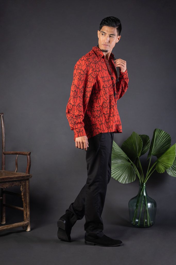 Male model wearing Hilo Shirt L-S in a Kapualiko Pattern and Fiery Red-Black - Side View