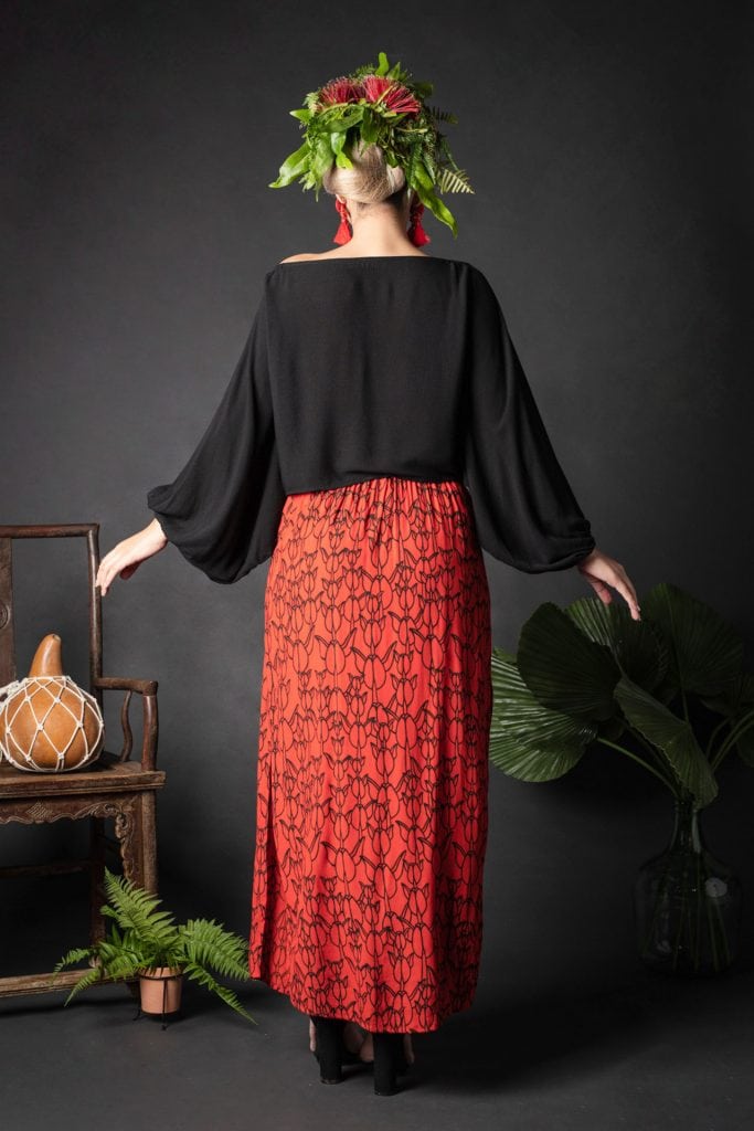 Female model wearing Kahiki Skirt Long in a Kapualiko Pattern in Fiery Red-Black - Back View