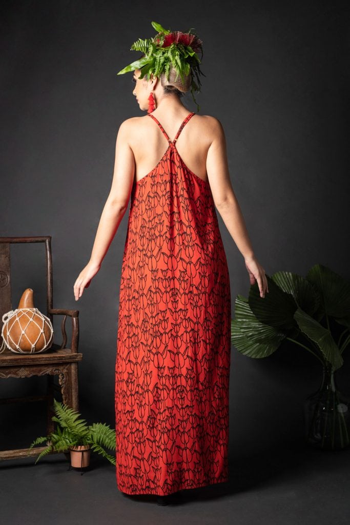 Female model wearing Keahou Dress in a Kapualiko Fiery Red/Black Color - Back View
