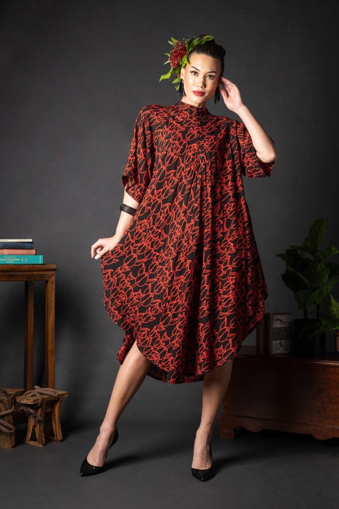 Female model wearing Koali Cut Dress in a Kapualiko Pattern in Black-Fiery Red - Front View