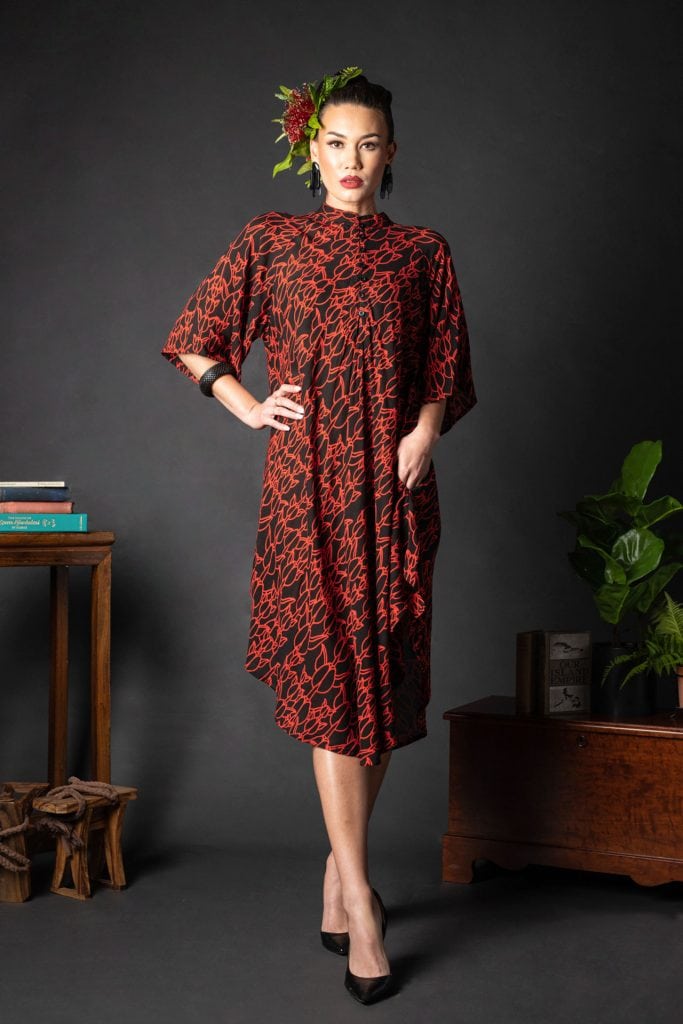 Female model wearing Koali Cut Dress in a Kapualiko Pattern in Black-Fiery Red - Front View