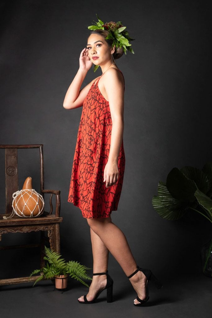 Female model wearing Kuakini Short Dress in a Kapualiko Pattern in Black-Fiery Red - Side View