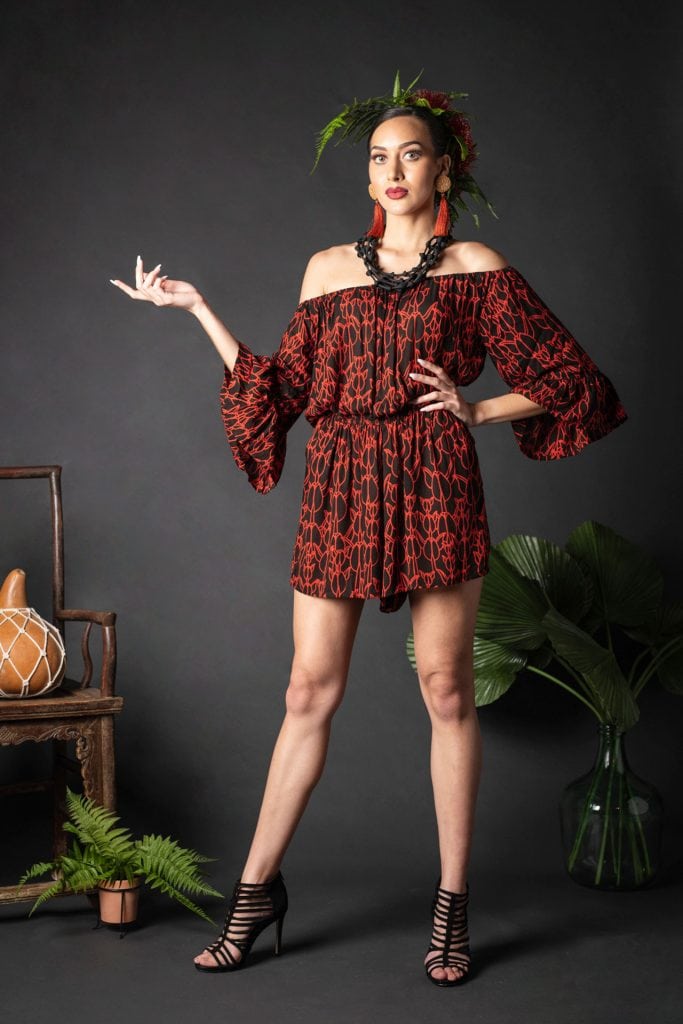 Female wearing a Manako Romper in Kapualiko Pattern and Black-Fiery Red - Front View