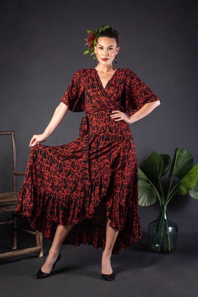 Female model wearing a Sepania Dress in Kapualiko Pattern and Black-Fiery Red - Front View