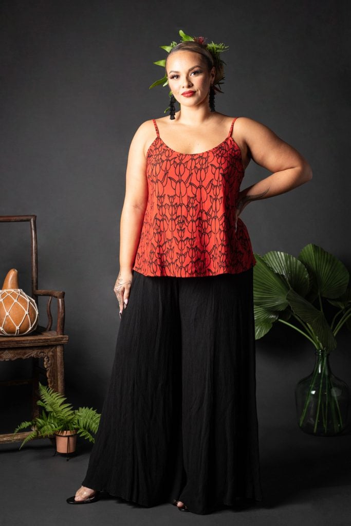 Female model wearing a Manaola Top 6 in a Kapualiko pattern and Fiery Red and Black Color - Front View