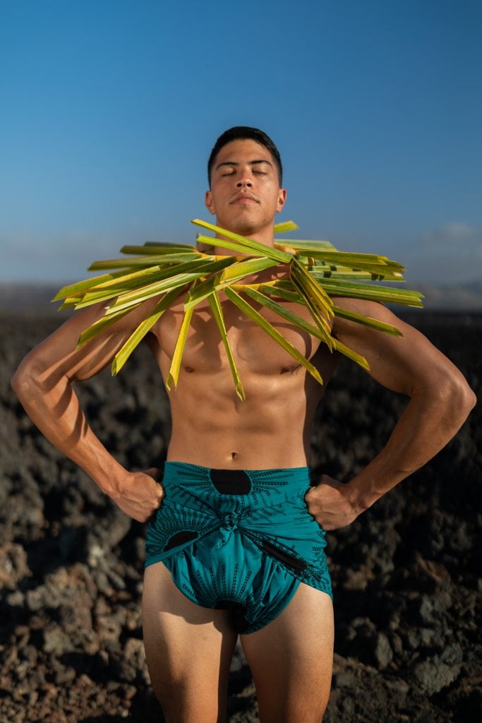 Male model wearing a Pareo in Dragonfly/Black Color and Kanehoalani Pattern - Front View