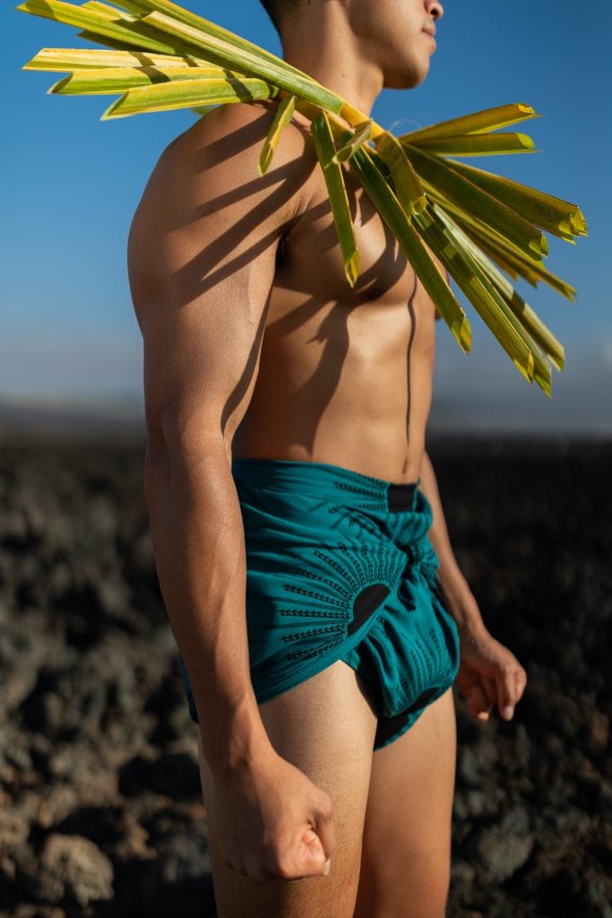 Male model wearing a Pareo in Dragonfly/Black Color and Kanehoalani Pattern - Side View