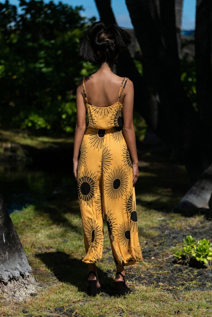 Female model wearing Leahi Jumpsuit in Kanehoalani Pattern - Back View