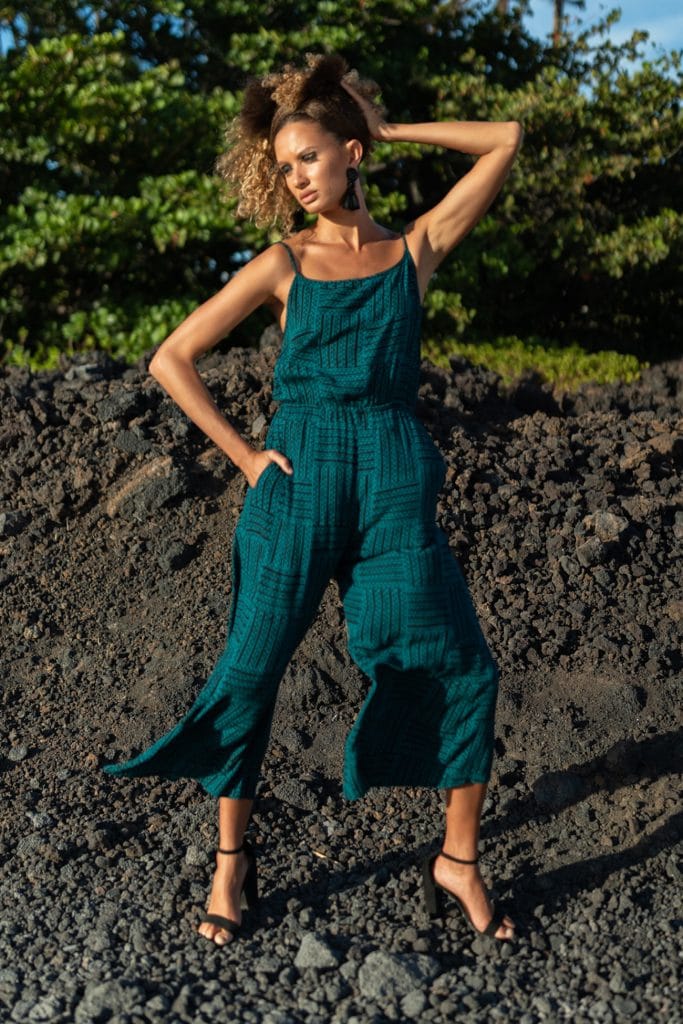 Female model wearing Leahi Jumpsuit in Black/Teal - Front View