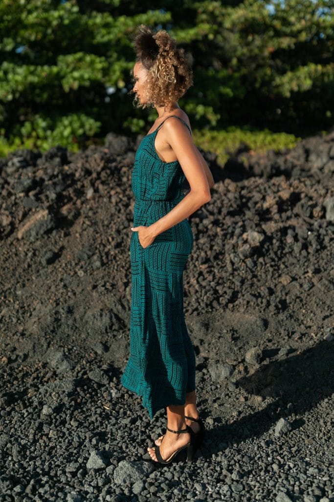 Female model wearing Leahi Jumpsuit in Black/Teal - Side View