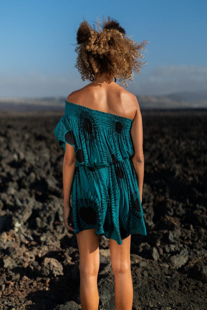 Female model wearing Oneka Short Dress in in Dragonfly/Black Color and Kanehoalani Pattern - Back View