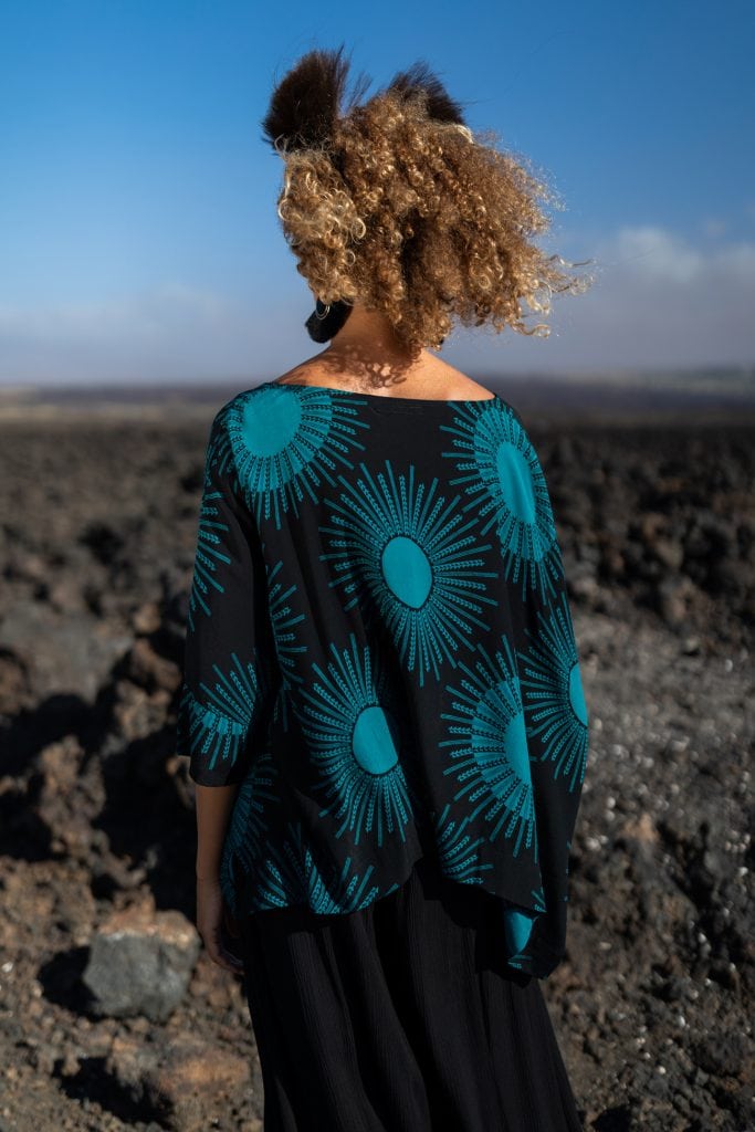 Female model wearing Puako Kaftan Shirt in in Dragonfly/Black Color and Kanehoalani Pattern - Back View