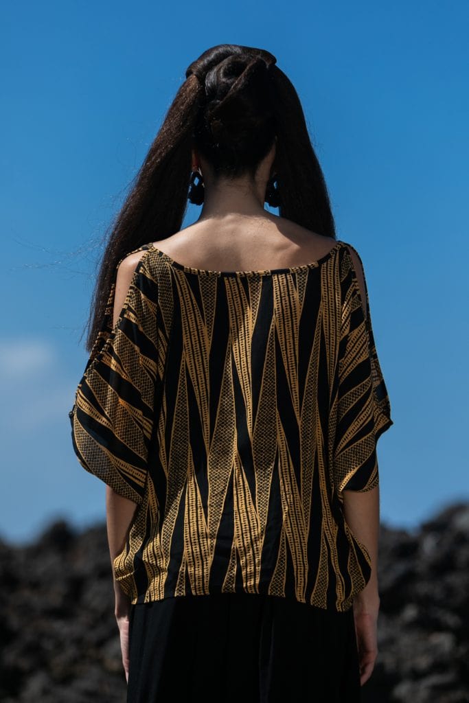 Female model wearing 3/4 Sleeve Shirt in Gold and Black - Back View