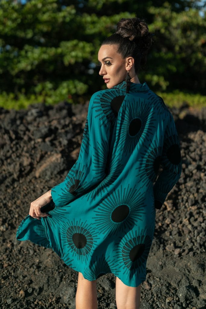 Female model wearing Waiaka Short Dress in in Dragonfly/Black Color and Kanehoalani Pattern - Back View