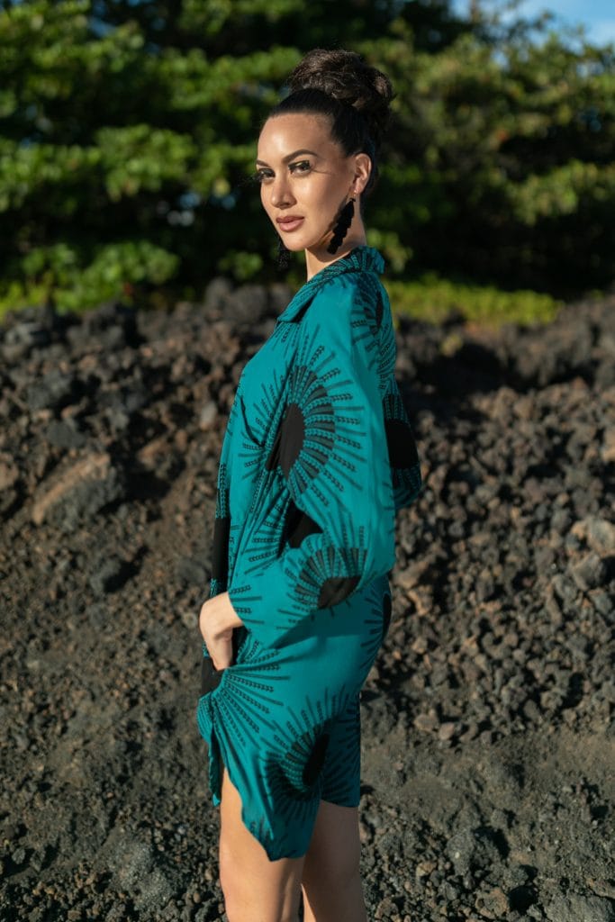 Female model wearing Waiaka Short Dress in in Dragonfly/Black Color and Kanehoalani Pattern - Side View