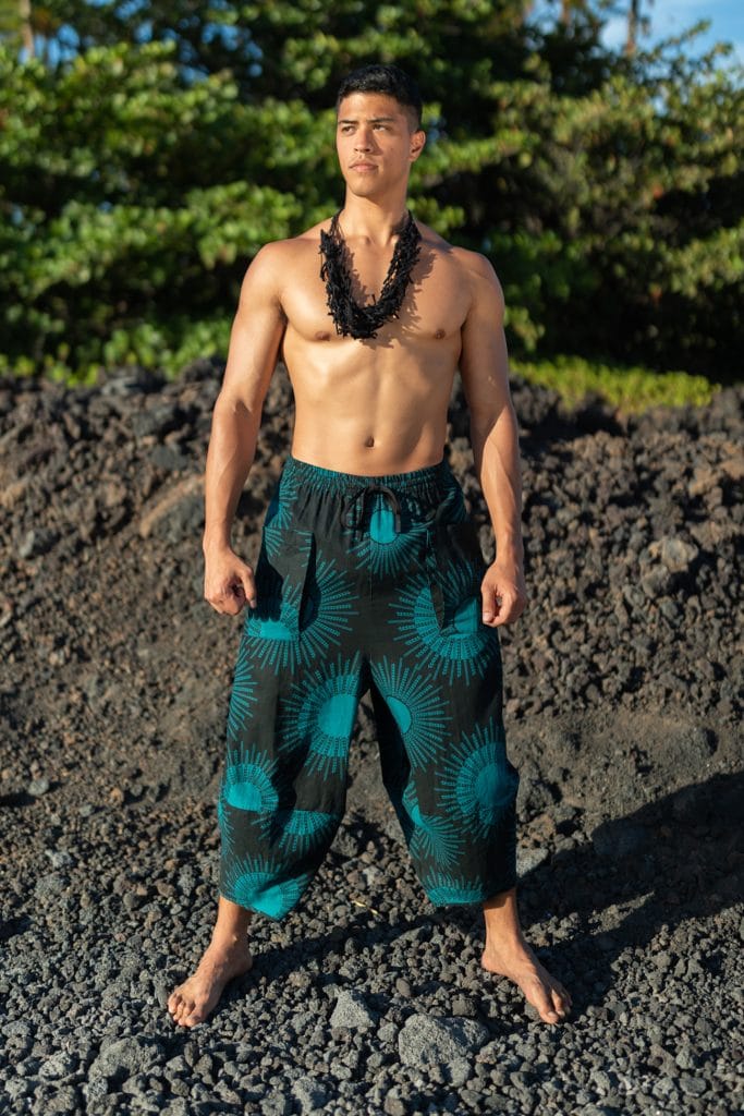 Male model wearing Waiola Pant in in Dragonfly/Black Color and Kanehoalani Pattern - Front View