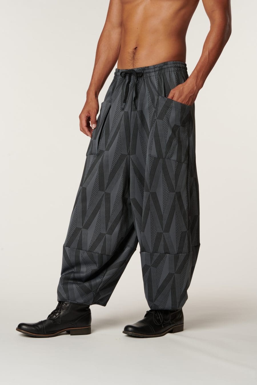 Male model wearing Waiola Pant in a Kanaola Print and Grey/Black Color - Front View