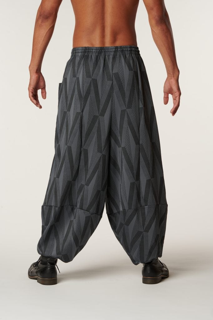 Male model wearing Waiola Pant in a Kanaola Print and Grey/Black Color - Back View