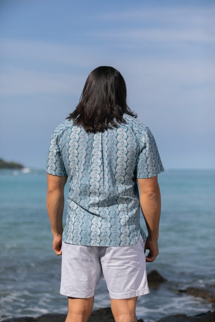 Male model wearing Aloha Short Sleeve in a Lei Kupee Print and Real Teal/Tofu Color - Back View