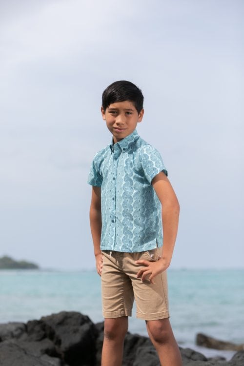 Boy model wearing Keiki S-S in a Lei Kupee Print and Blue Tint/Real Teal Color - Front View