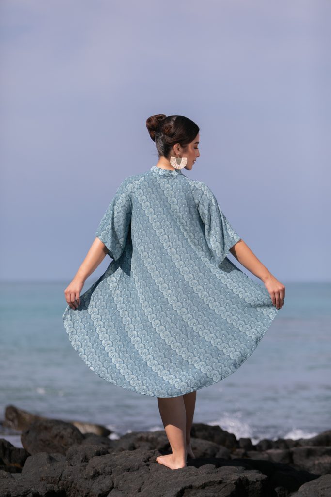 Female model wearing a Koali in Lei Kupee Print and Real Teal/Blue Tint Color - Front View
