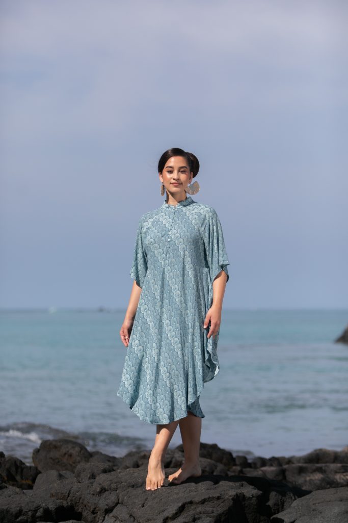Female model wearing a Koali in Lei Kupee Print and Real Teal/Blue Tint Color - Front View