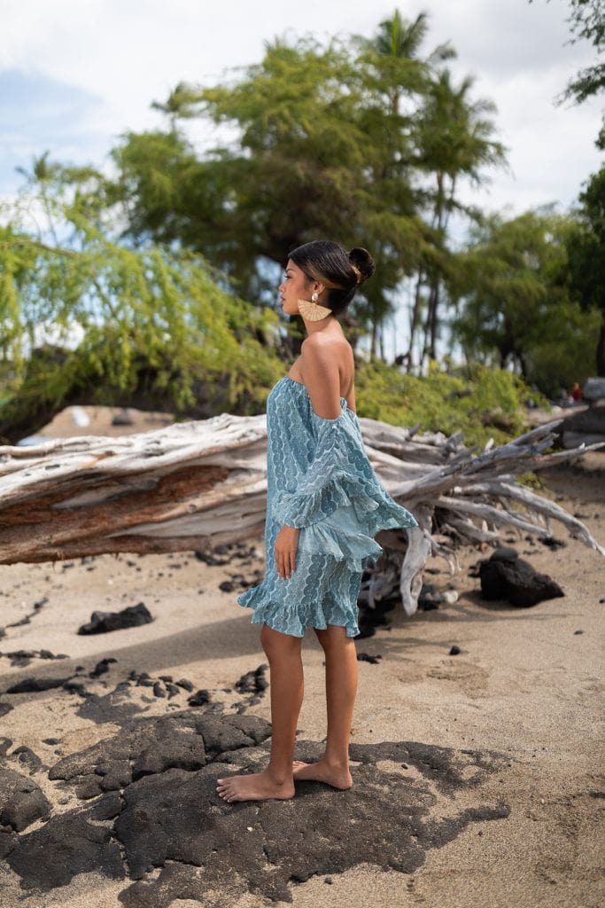 Female model wearing Leinani Dress in Lei Kupee Print and Blue Tint/Real Teal Color - Side View