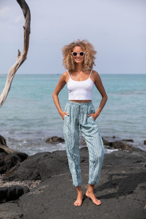 Female model wearing Uluhala Joggers in Lei Kupee Print and a Blue Tint/Real Tint Color - Front View