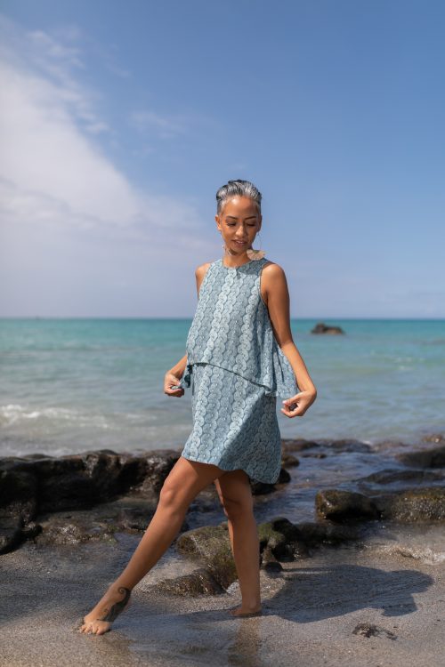 Female model wearing Waiulu Top in Lei Kupee Print and Real Teal/Blue Teal Color - Front View