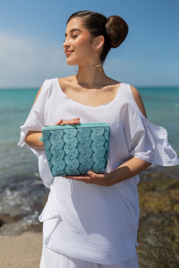 Female model holding a Lei Bag in Lei Kupee Print and Blue Tint/Real Teal Color