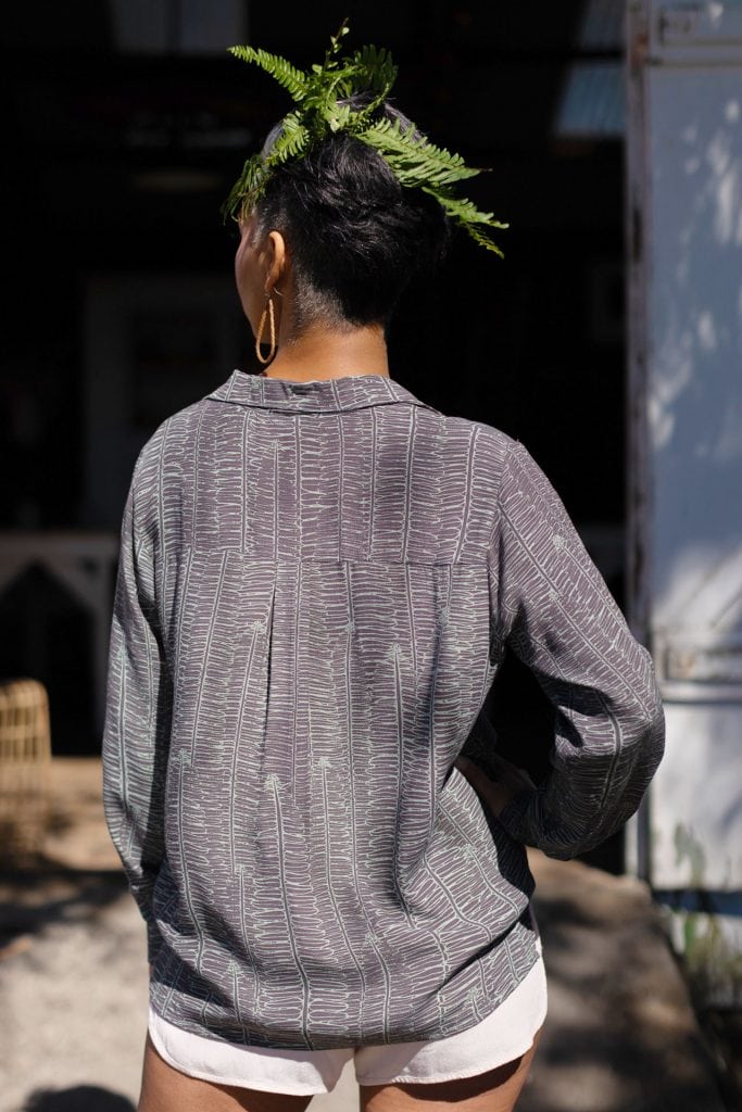 Female model wearing Palulu Shirt in Kupukupu Pattern - Back View