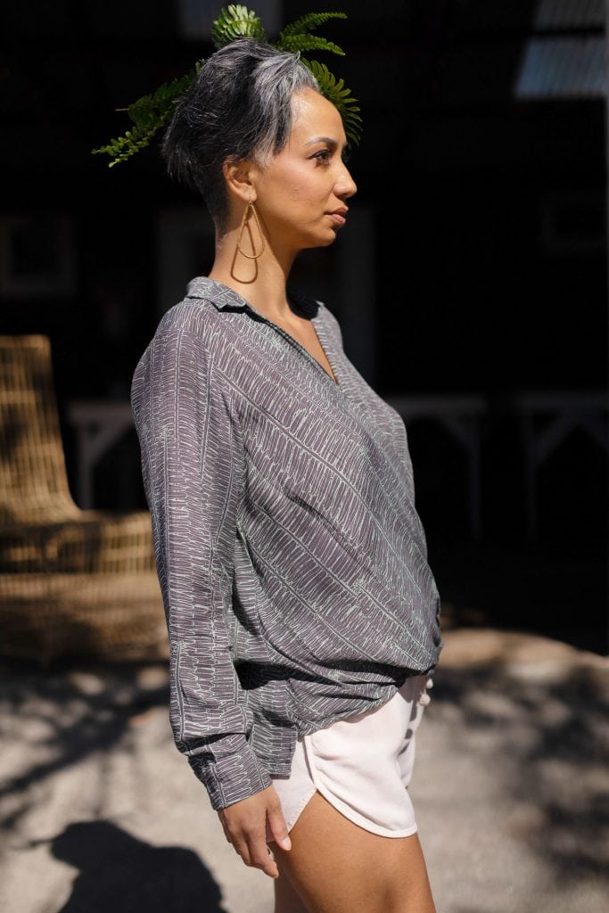 Female model wearing Palulu Shirt in Kupukupu Pattern - Side View