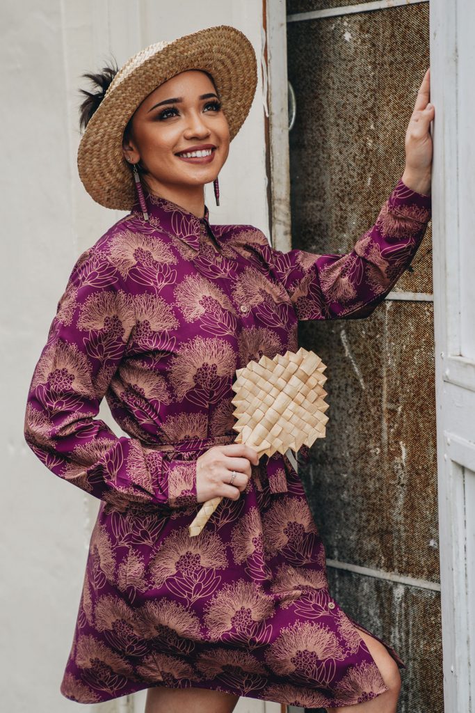 Female model wearing Keao Dress in Purple Potion, Lion, and Kalihilehua Pattern